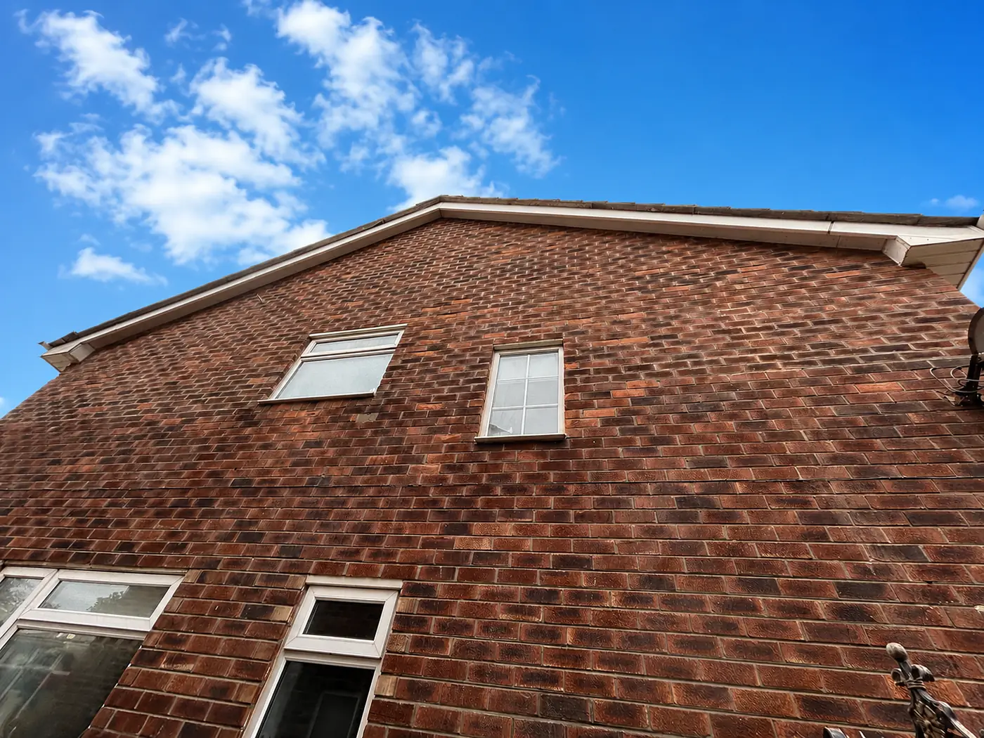 A brick gable elevation with its mortar joints raked out and repointed, weathertight again