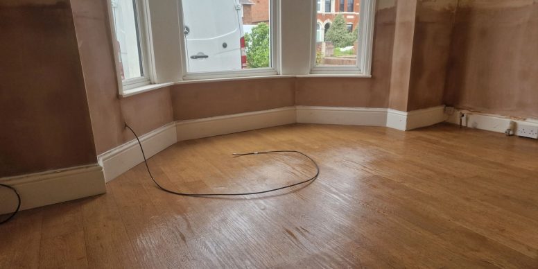 Freshly plastered walls in a period bay room after a damp proof course