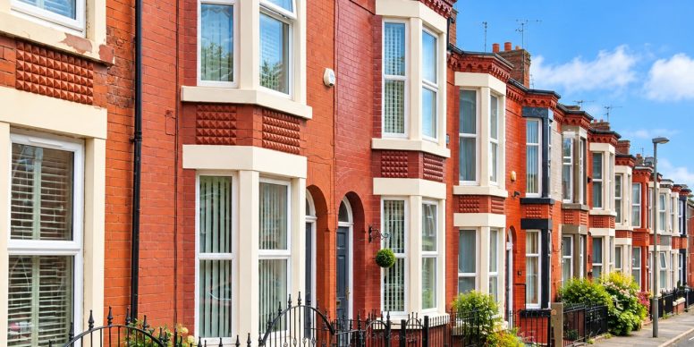 A sunlit row of red brick Victorian bay fronted terraces on a Liverpool street, the housing stock most of our damp proofing work is done in.